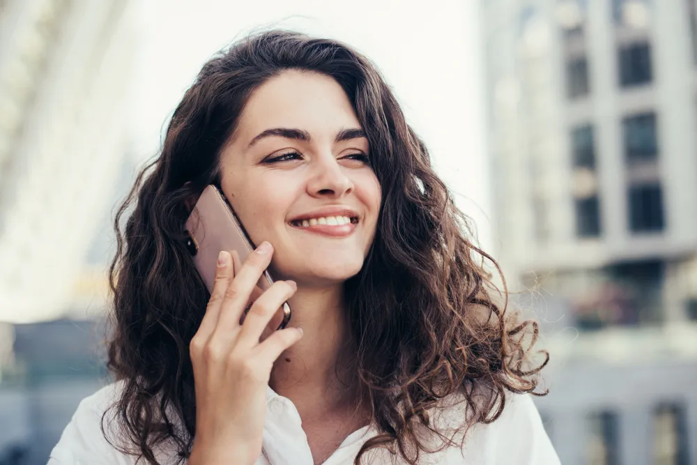 woman talking on a mobile phone in a city