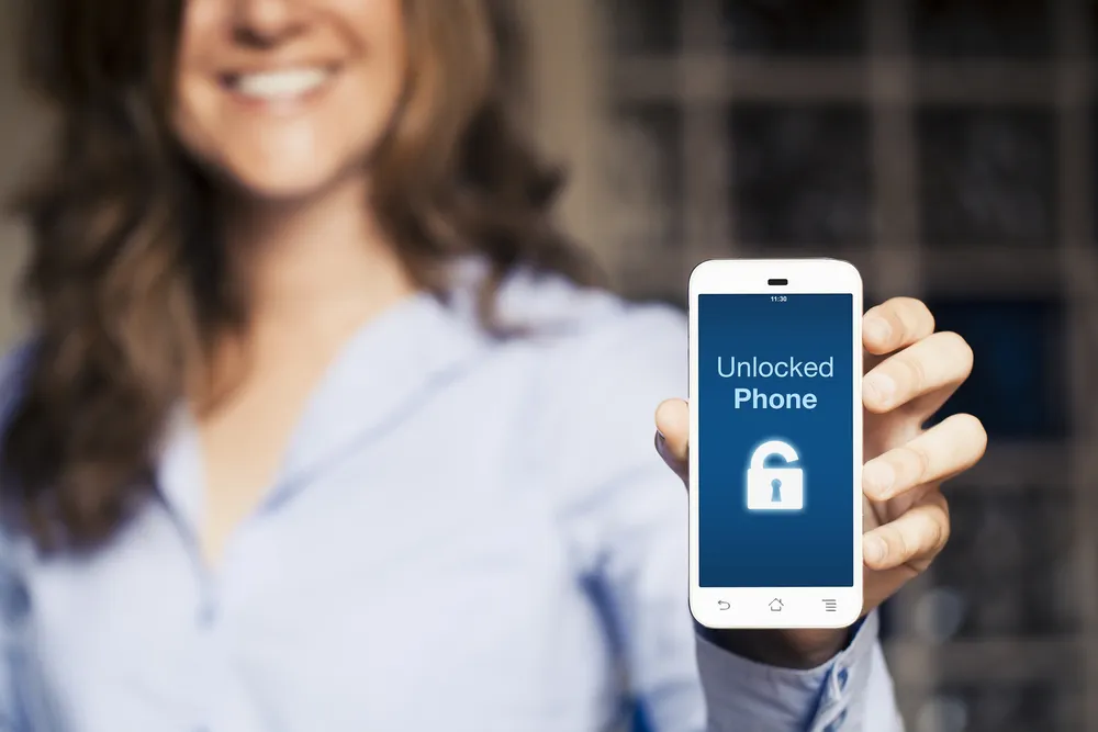 women holding an unlocked mobile phone