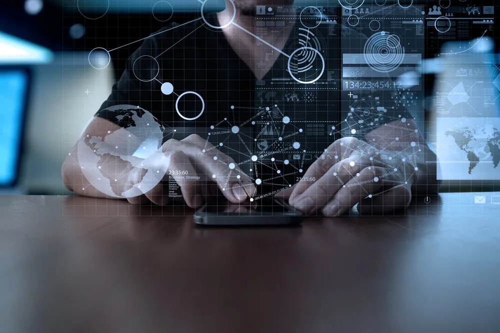 blueprint on top of hands using a mobile phone