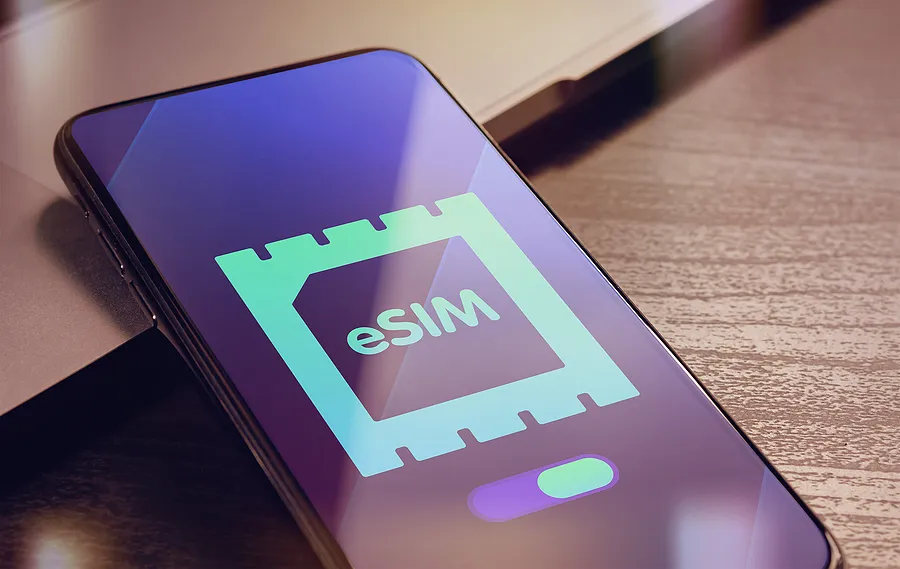 smartphone on desk showing eSIM card logo