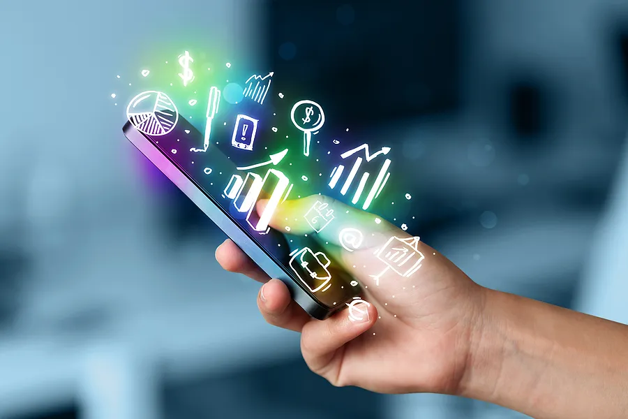 Hand holding a cell phone with icons above it.